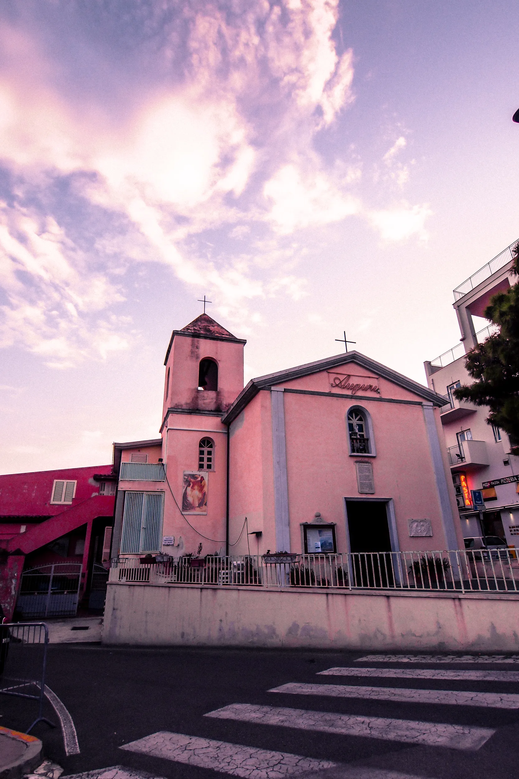 Église de Cala Gonone sous un ciel rose au coucher du soleil en Sardaigne